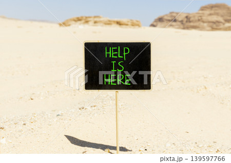 Help is here and support words symbol. Concept words Help is here on beautiful blackboard. Beautiful Sinai desert sand background. Business help is here and support concept. Copy space. 139597766