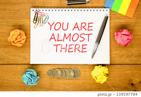 You are almost there words symbol. Concept words You are almost there on beautiful white note. Beautiful wooden background. Business You are almost there motivational support concept. Copy space. 139597784