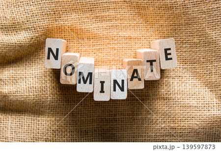 Nominate word symbol. Concept word Nominate on beautiful wooden blocks. Beautiful canvas background. Business support help nominate word concept. Copy space. 139597873