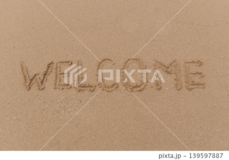 Business hello and welcome concept. Concept word Welcome written on beautiful ocean sea sand beach. Beautiful ocean sand beach background, copy space. Business hello and welcome concept. Business hello and welcome concept. Concept word Welcome written on beautiful ocean sea sand beach. Beautiful ocean sand beach background, copy space. Business hello and welcome concept. 139597887