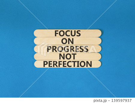 Progress or perfection words symbol. Concept words Focus on progress not perfection on beautiful wooden sticks. Beautiful blue paper background. Business progress or perfection concept. Copy space. 139597937