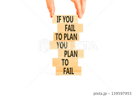 Planning to fail symbol. Concept words If you fail to plan you plan to fail on beautiful wooden blocks. Beautiful white background. Businessman hand. Business planning to fail concept. Copy space. Planning to fail symbol. Concept words If you fail to plan you plan to fail on beautiful wooden blocks. Beautiful white background. Businessman hand. Business planning to fail concept. Copy space. 139597955