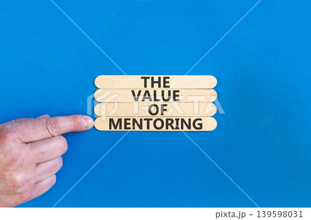 The value of mentoring words symbol. Concept words The value of mentoring on beautiful wooden sticks. Beautiful blue background. Businessman hand. Business the value of mentoring concept. Copy space The value of mentoring words symbol. Concept words The value of mentoring on beautiful wooden sticks. Beautiful blue background. Businessman hand. Business the value of mentoring concept. Copy space 139598031