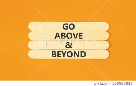 Go above and beyond words symbol. Concept words Go above and beyond on beautiful wooden sticks. Beautiful orange background. Business motivational Go above and beyond concept. Copy space. Go above and beyond words symbol. Concept words Go above and beyond on beautiful wooden sticks. Beautiful orange background. Business motivational Go above and beyond concept. Copy space. 139598033