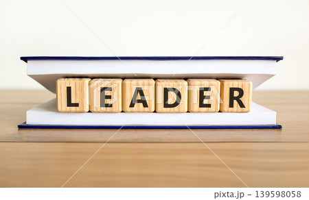 Leadership and leader symbol. Concept word Leader on beautiful wooden blocks in beautiful book. Beautiful wooden table white background. Business leader and leadership concept. Copy space. Leadership and leader symbol. Concept word Leader on beautiful wooden blocks in beautiful book. Beautiful wooden table white background. Business leader and leadership concept. Copy space. 139598058