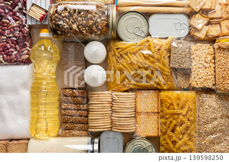 Home food supplies for quarantine and isolation, including canned food, cereals, pasta, and essential staples for survival, survival during military operations, the concept of stay at home 139598250