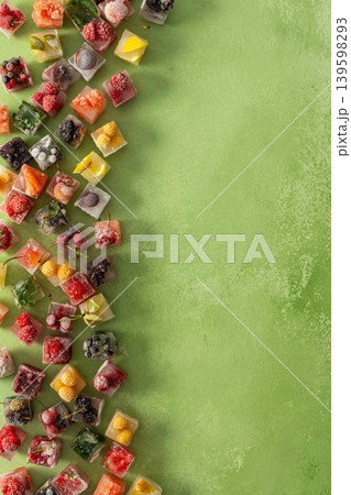 Ice cubes with frozen berries and fruits and mint on a green background Ice cubes with frozen berries and fruits and mint on a green background 139598293