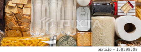 Home food supplies for quarantine and isolation, including canned food, cereals, pasta, and essential staples for survival, survival during military operations, the concept of stay at home, banner Home food supplies for quarantine and isolation, including canned food, cereals, pasta, and essential staples for survival, survival during military operations, the concept of stay at home, banner 139598308