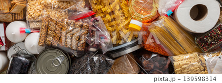 Canned goods, cereals, and pasta stored for quarantine and isolation, ensuring long-term survival and food security at home, survival during military operations, the concept of stay at home, banner 139598314