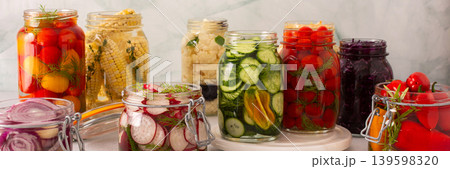 Fresh vegetables like cabbage, tomatoes, cucumbers and radishes, onions, corn, peppers and cauliflower, fermenting naturally to boost health and preserve nutrients, banner Fresh vegetables like cabbage, tomatoes, cucumbers and radishes, onions, corn, peppers and cauliflower, fermenting naturally to boost health and preserve nutrients, banner 139598320