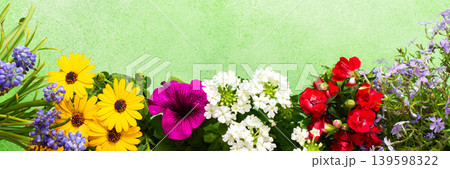Beautiful spring flowers adorn a balcony, creating a cheerful atmosphere. The colorful blooms in various shades brighten the terrace, celebrating the arrival of warmer days, banner Beautiful spring flowers adorn a balcony, creating a cheerful atmosphere. The colorful blooms in various shades brighten the terrace, celebrating the arrival of warmer days, banner 139598322