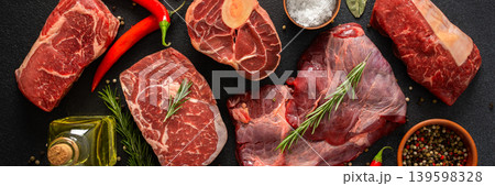 Various cuts of beef steak are shown with herbs, spices, and oil on a dark surface. Perfect for those looking to prepare or grill different beef dishes at home, banner Various cuts of beef steak are shown with herbs, spices, and oil on a dark surface. Perfect for those looking to prepare or grill different beef dishes at home, banner 139598328