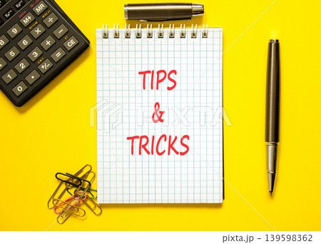 Tips and tricks symbol. Concept words Tips and tricks on beautiful white note. Beautiful yellow background. Black pen. Black calculator. Business tips tricks motivational support concept. Copy space. Tips and tricks symbol. Concept words Tips and tricks on beautiful white note. Beautiful yellow background. Black pen. Black calculator. Business tips tricks motivational support concept. Copy space. 139598362
