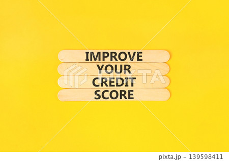 Improve your credit score words symbol. Concept words Improve your credit score on beautiful wooden sticks. Beautiful yellow background. Business improve your credit score concept. Copy space. Improve your credit score words symbol. Concept words Improve your credit score on beautiful wooden sticks. Beautiful yellow background. Business improve your credit score concept. Copy space. 139598411