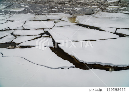 Ice Floes and Broken River Ice Floating on Dark Water in Late Winter Morning Ice Floes and Broken River Ice Floating on Dark Water in Late Winter Morning 139598455
