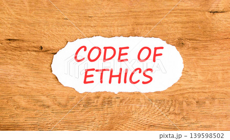 Code of ethics words symbol. Concept words Code of ethics on beautiful white paper. Beautiful wooden background. Business Code of ethics concept. Copy space. Code of ethics words symbol. Concept words Code of ethics on beautiful white paper. Beautiful wooden background. Business Code of ethics concept. Copy space. 139598502