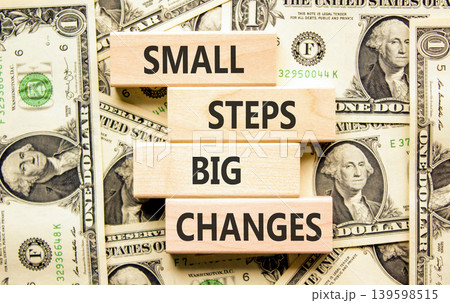 Small steps big changes symbol. Concept words Small steps big changes on beautiful wooden blocks. Beautiful dollar bills background. Business motivational small steps big changes concept. Copy space. 139598515