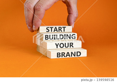 Start building your brand words symbol. Concept words Start building your brand on beautiful wooden blocks. Beautiful orange background. Business start building your brand concept. Copy space. Start building your brand words symbol. Concept words Start building your brand on beautiful wooden blocks. Beautiful orange background. Business start building your brand concept. Copy space. 139598516