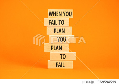 Planning to fail symbol. Concept words When you fail to plan you plan to fail on beautiful wooden blocks. Beautiful orange paper background. Business planning to fail concept. Copy space. 139598549