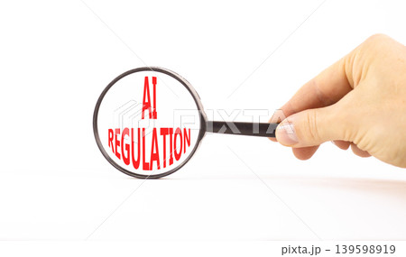 AI regulation symbol. Concept words AI artificial intelligence regulation on beautiful magnifying glass. Beautiful white background. Business AI artificial intelligence regulation concept. Copy space. AI regulation symbol. Concept words AI artificial intelligence regulation on beautiful magnifying glass. Beautiful white background. Business AI artificial intelligence regulation concept. Copy space. 139598919