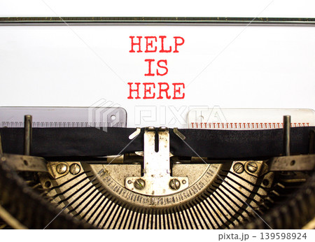 Help is here and support words symbol. Concept words Help is here typed on beautiful old retro typewriter. Beautiful white background. Business help is here and support concept. Copy space. Help is here and support words symbol. Concept words Help is here typed on beautiful old retro typewriter. Beautiful white background. Business help is here and support concept. Copy space. 139598924