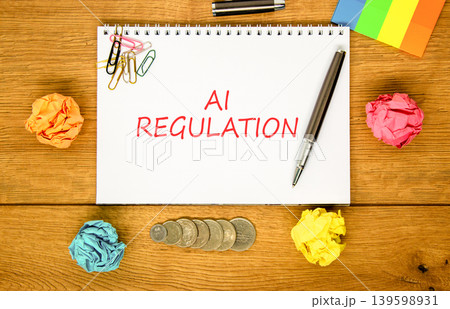 AI regulation symbol. Concept words AI artificial intelligence regulation on beautiful white note. Beautiful wooden background. Pen. Business AI artificial intelligence regulation concept. Copy space. AI regulation symbol. Concept words AI artificial intelligence regulation on beautiful white note. Beautiful wooden background. Pen. Business AI artificial intelligence regulation concept. Copy space. 139598931