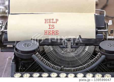 Help is here and support words symbol. Concept words Help is here typed on beautiful old retro typewriter. Beautiful white background. Business help is here and support concept. Copy space. 139599047