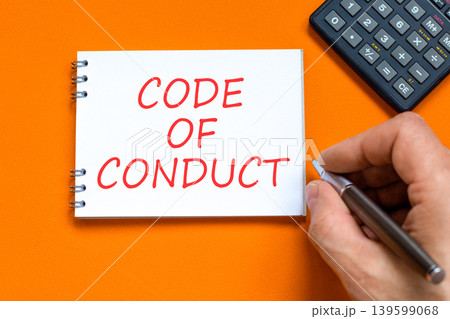 Code of conduct words symbol. Concept words Code of conduct on beautiful white note. Beautiful orange background. Businessman hand. Business Code of conduct concept. Copy space. 139599068
