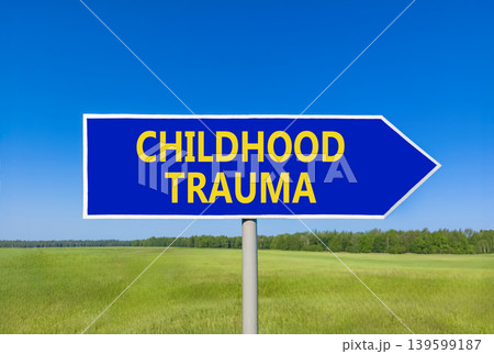 Childhood trauma words symbol. Concept words Childhood trauma on beautiful blue road sign. Beautiful blue sky green field background. Psychological childhood trauma support concept. Copy space. 139599187