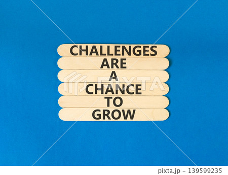 Challenge word symbol. Concept words Challenges are a chance to grow on beautiful wooden sticks. Beautiful blue paper background. Business challenges are a chance to grow concept. Copy space. Challenge word symbol. Concept words Challenges are a chance to grow on beautiful wooden sticks. Beautiful blue paper background. Business challenges are a chance to grow concept. Copy space. 139599235