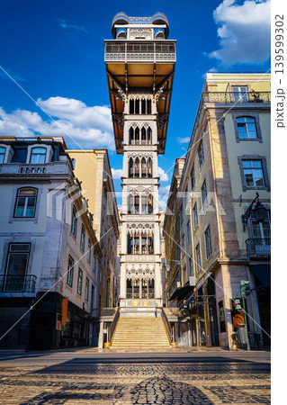 Iconic Santa Justa elevator or Carmo lift in historic center, Lisbon, Portugal on sunny summer day. Iron tower, blue sky with clouds, famous landmark, travel destination, heritage engineering, neo Iconic Santa Justa elevator or Carmo lift in historic center, Lisbon, Portugal on sunny summer day. Iron tower, blue sky with clouds, famous landmark, travel destination, heritage engineering, neo 139599302