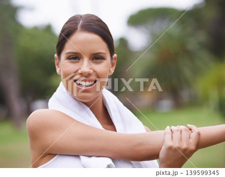 Park, portrait or happy woman stretching arms in running training, exercise or outdoor workout. Nature, smile or healthy girl runner with towel, ready to start activity for fitness, sports or warm up 139599345