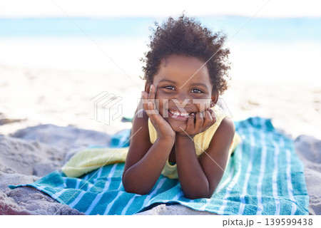 Smile, african child and portrait on beach sand, towel and summer holiday with sunshine in nature. Black girl, young and happy face to relax on vacation, cape town and ocean for wellness in outdoor 139599438