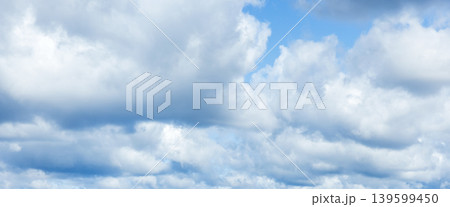 Expansive blue sky filled with layered puffy white clouds Expansive blue sky filled with layered puffy white clouds 139599450