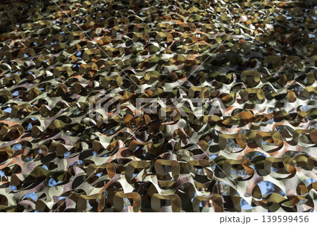 Layered camouflage netting with green and brown patterns Layered camouflage netting with green and brown patterns 139599456