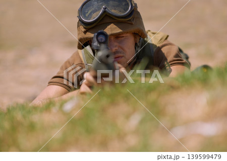 Military, shooting and aim with man and gun in nature for war, conflict and patriotism. Army, surveillance and security with person and sniper rifle training for soldier, battlefield and veteran 139599479