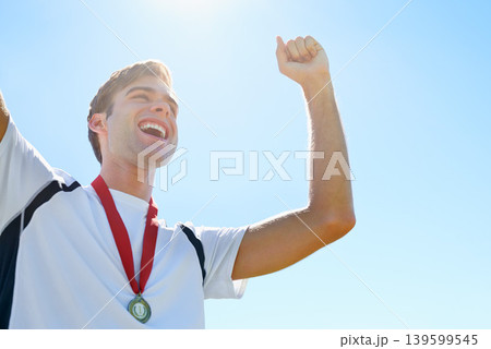 Winner, man or athlete with sports medal for achievement, success and celebration in running competition. Happy or excited runner with fist, power and wow for gold award. prize or goals on a blue sky Winner, man or athlete with sports medal for achievement, success and celebration in running competition. Happy or excited runner with fist, power and wow for gold award. prize or goals on a blue sky 139599545