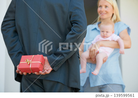 Husband, wife and hiding gift box for surprise, look and happiness with baby, love and appreciation. Present, romance and good news for marriage, relationship and announcement with romantic partner Husband, wife and hiding gift box for surprise, look and happiness with baby, love and appreciation. Present, romance and good news for marriage, relationship and announcement with romantic partner 139599561