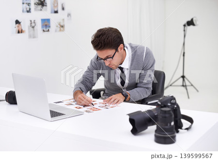 Writing, photography and man in office editing with production, process and technology. Professional, editor and creative person working on desk with photoshoot results, review or notes for magazine Writing, photography and man in office editing with production, process and technology. Professional, editor and creative person working on desk with photoshoot results, review or notes for magazine 139599567
