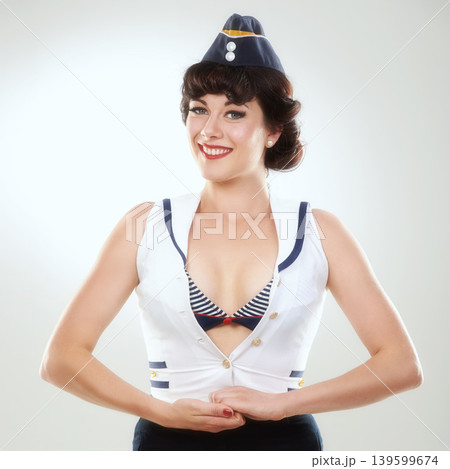 Travel, happy air hostess and portrait of woman in studio isolated on a white background in Spain. Fashion, flight attendant and face of retro sailor person, pin up girl and stewardess model in hat Travel, happy air hostess and portrait of woman in studio isolated on a white background in Spain. Fashion, flight attendant and face of retro sailor person, pin up girl and stewardess model in hat 139599674