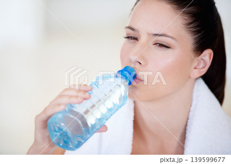 Tired, thinking or woman drinking water on break after exercise, workout or fitness training in gym. Fatigue, healthy or thirsty sports athlete with liquid bottle for wellness, rest or hydration 139599677