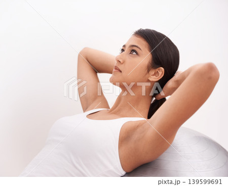 Fitness, exercise and girl with gym ball, commitment and energy for health, wellness and training. Workout, pilates and woman with equipment for balance, weight loss and body care on white background Fitness, exercise and girl with gym ball, commitment and energy for health, wellness and training. Workout, pilates and woman with equipment for balance, weight loss and body care on white background 139599691