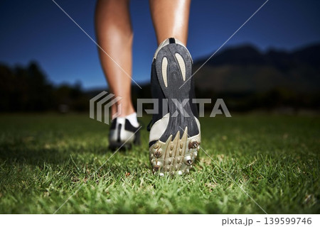 Person, feet and fitness at night for workout, exercise or outdoor cardio in health and wellness in nature. Closeup of athlete legs, walking or running on green grass in the late evening for training Person, feet and fitness at night for workout, exercise or outdoor cardio in health and wellness in nature. Closeup of athlete legs, walking or running on green grass in the late evening for training 139599746