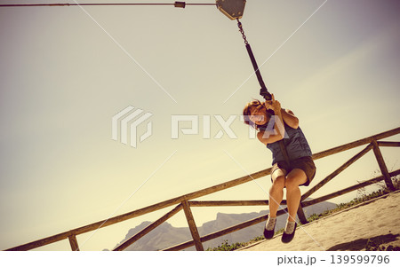 Adult woman having fun on zipline 139599796