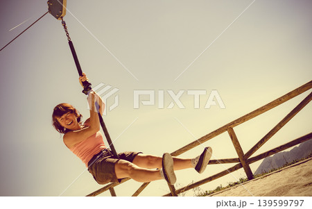 Adult woman having fun on zipline 139599797