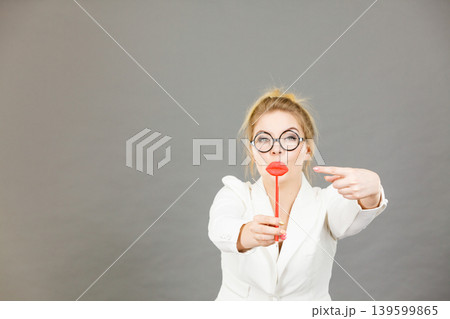 Happy elegant woman holding carnival accessoies on stick 139599865