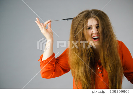 Woman having tangled hair 139599903