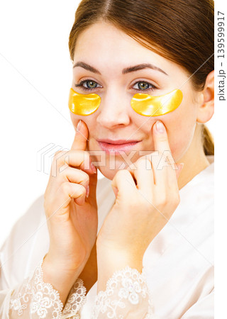 Woman with gold patches under eyes 139599917