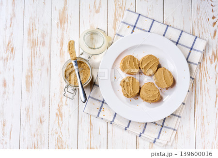 Liver pate on sliced baguette on a plate, top view. 139600016