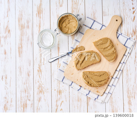 bread with beef liver pate, on a white wooden table, top view. bread with beef liver pate, on a white wooden table, top view. 139600018